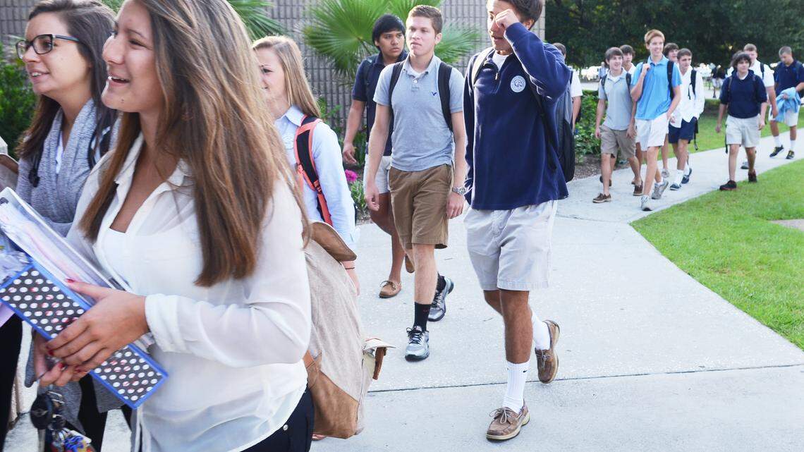 Hilton Head Island High School students troop toward the main entrance just before the school's new, later start time of 8:30 a.m. on Aug. 21. Before this year, the school day commenced at 7:45.