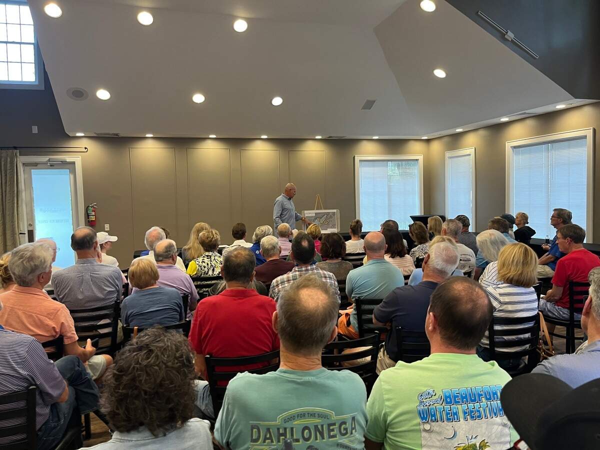 An informational meeting about large-scale housing development projects planned for Cane and Gibson islands drew a crowd of about 80 people to the Cat Island Club Sunday.