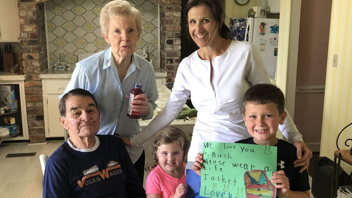 In the kitchen after the rescue, from left, Dr. Tony Bush, Patricia Bush, Marci Burris and her two children, Miabella and Rocco.