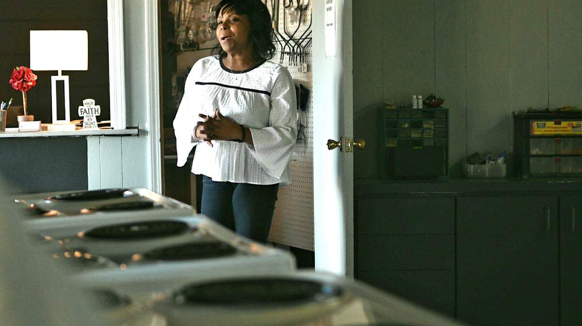 Tamah Rivers, owner of Reconditioned Appliances in Beaufort, stands in her store on Wednesday afternoon and discusses how women “have been doing some powerful things in the world’” as she discussed owning her own business after having a troubled past.