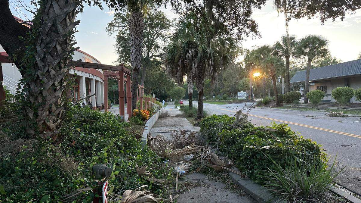 Sidewalks near Hilton Head’s Coligny Plaza were coated with branches and debris Thursday morning after Idalia’s steady lashing of rain and wind throughout Wednesday.
