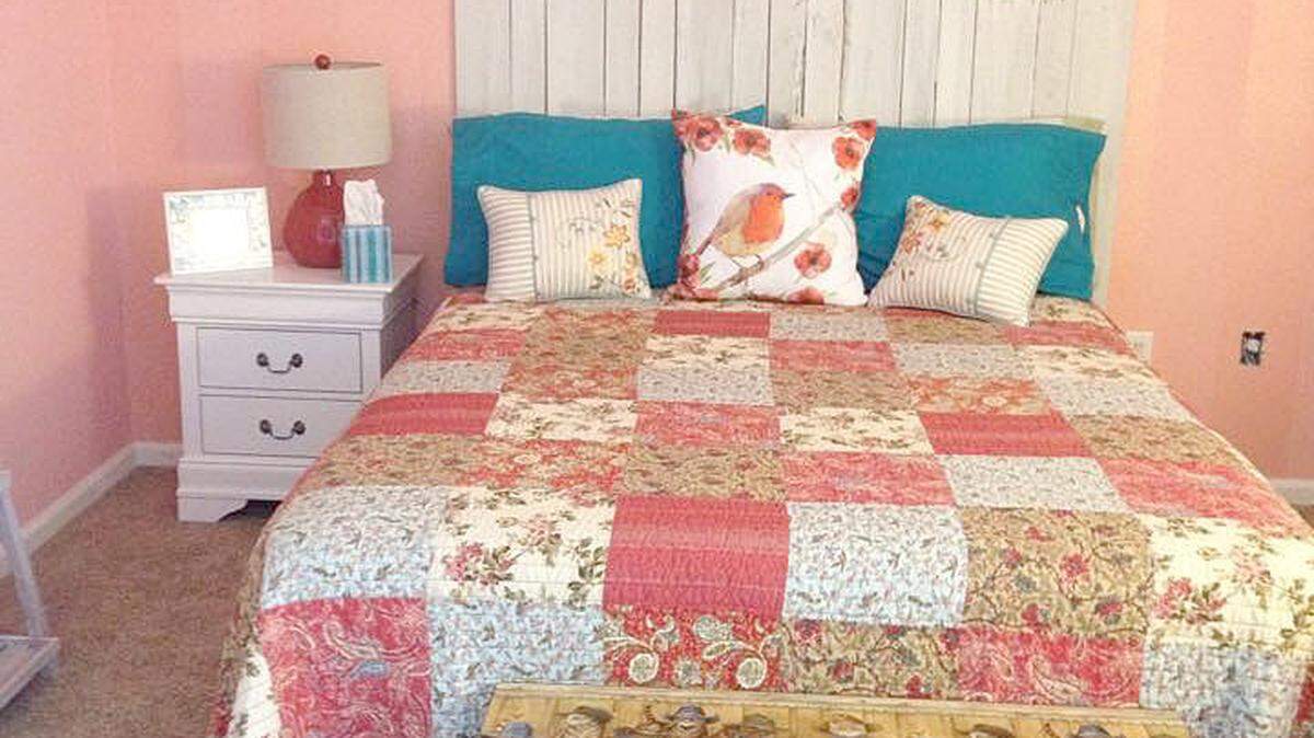 With help from a handyman, stripes were painted on the wall behind the bed using a varnish with a satin finish for a subtle contrast.
