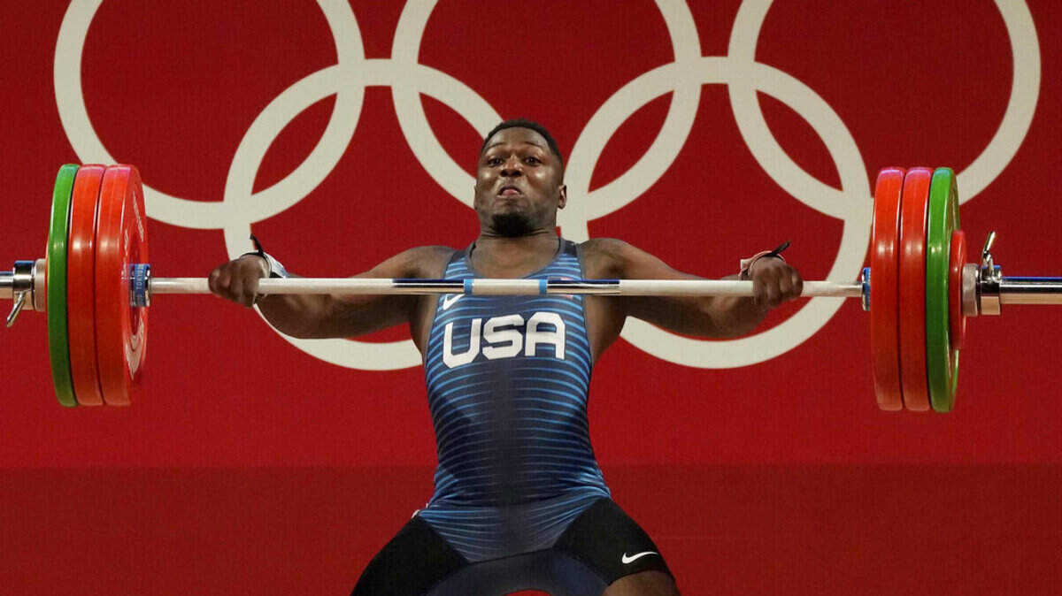 Clarence Cummings Jr. of the United States competes in the men’s 73kg weightlifting event, at the 2020 Summer Olympics, Wednesday, July 28, 2021, in Tokyo, Japan.