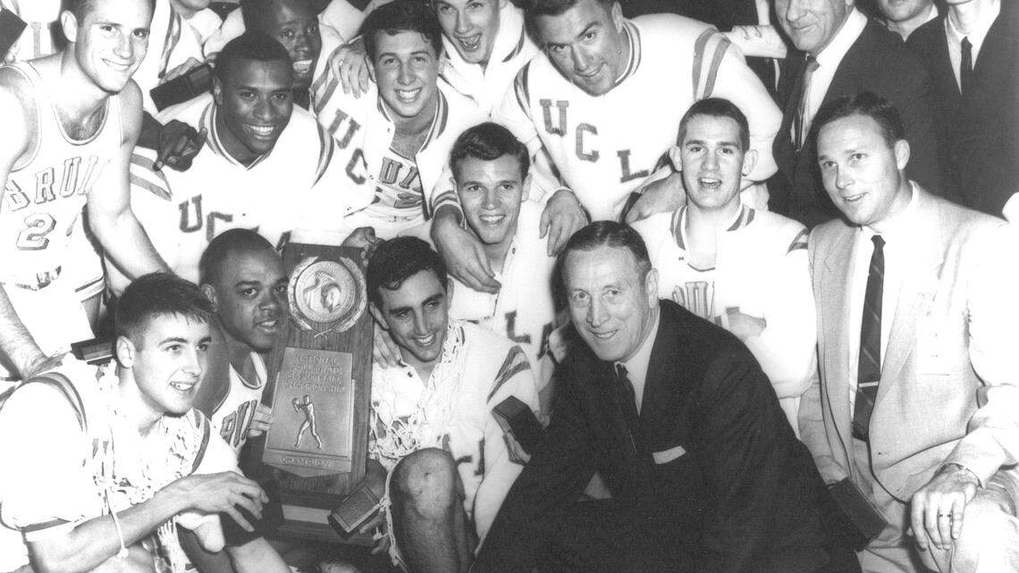 Coach John Wooden is surrounded by his UCLA team that won the 1964 NCAA basketball championship in Kansas City. It was the first of 10 titles in 12 years for Wooden, who remained a life-long friend of Kenny Washington.