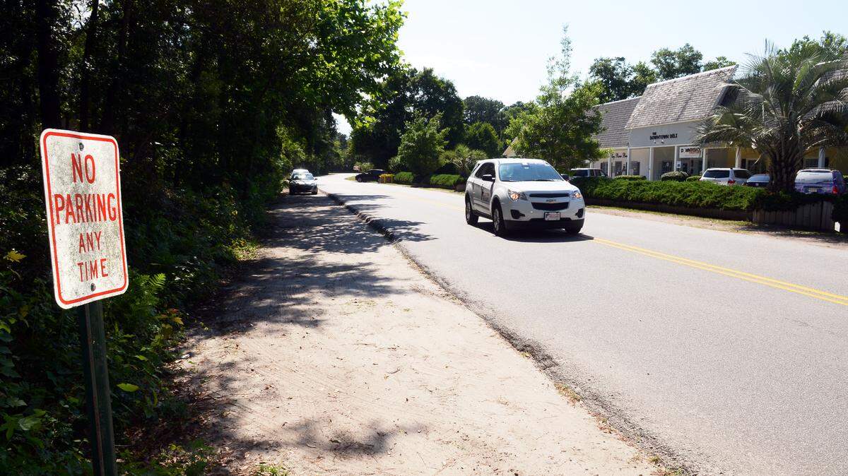 A vehicle moves down Bluffton's Dr. Mellichamp Drive on Monday. The S.C. Department of Transportation has agreed to drop the speed limit along the road and nearby Boundary Street in Old Town Bluffton. The change, from 30 miles per hour to 25, will also allow for the addition of some much needed parking spots along the roads -- including some angled parking on Dr. Mellichamp Drive -- to ease congestion. In all, the town plans to add between 70 to 100 parking spots.