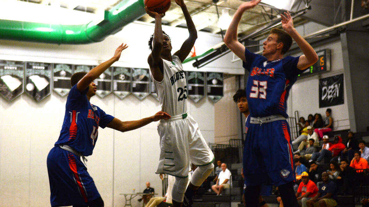 Bluffton?s Javonne Watson tries to shoot the ball as Bolles School?s Amari Terry, left, and Jonathan DeWane, right, from try to block him during the championship game of the 2015 Bobcat Classic basketball tournament on Wednesday night at Bluffton High School in Bluffton.