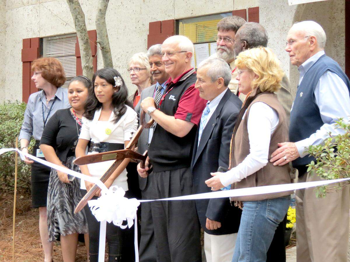 Narendra Sharma, with Neighborhood Outreach Connection, and Hilton Head Island Mayor Drew Laughlin at the 2012 ribbon-cutting marking the opening of a new Program Center. The center provides students with tutoring and internet-based learning in after-school programs.