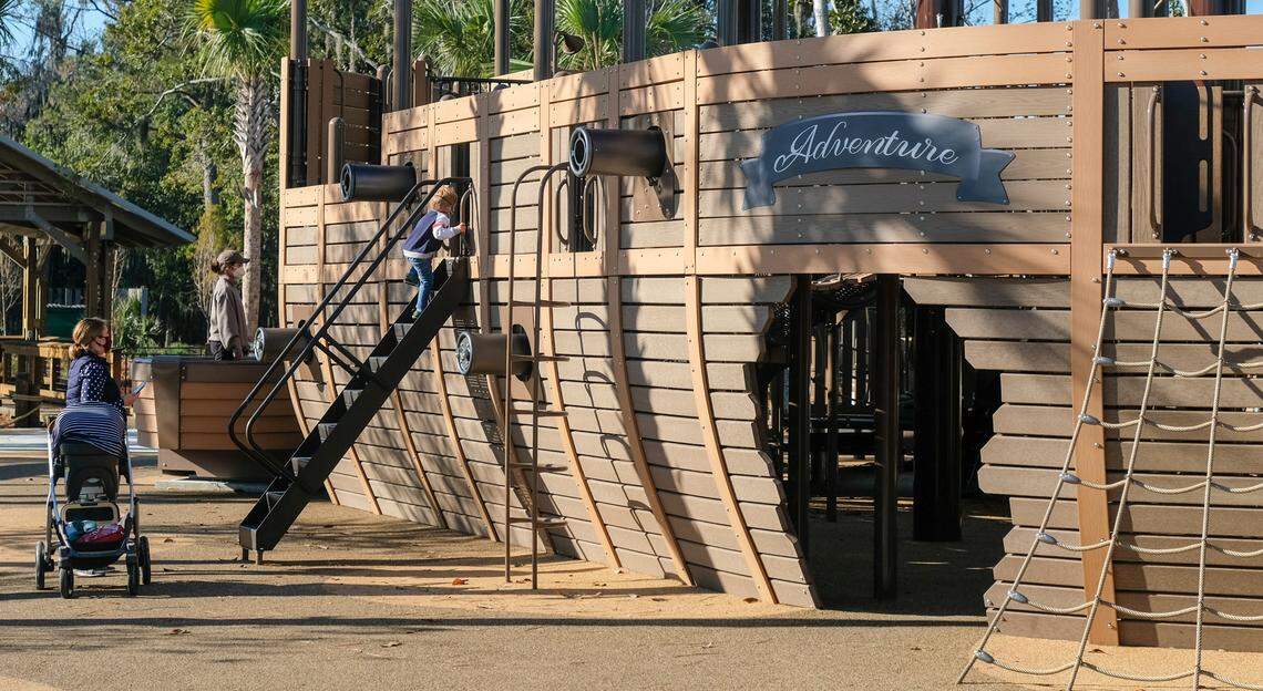 A child peeks inside before entering the “Adventure” play ship on Thursday, Dec. 10, 2020 in the Adventure Playground at the newly opened Lowcountry Celebration Park on Hilton Head Island. While finishing touches are still underway, the final costs for the 10-acre park will be around $14.1 million.