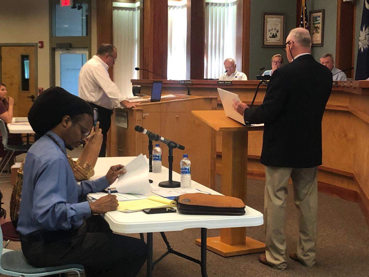 Town of Hilton Head Island staff attorney Brian Hulbert asks deputy finance director Steven Markiw questions about resident and restaurant owner Taiwan Scott’s business license at a special meeting of the Hilton Head Island Town Council on April 25, 2019.