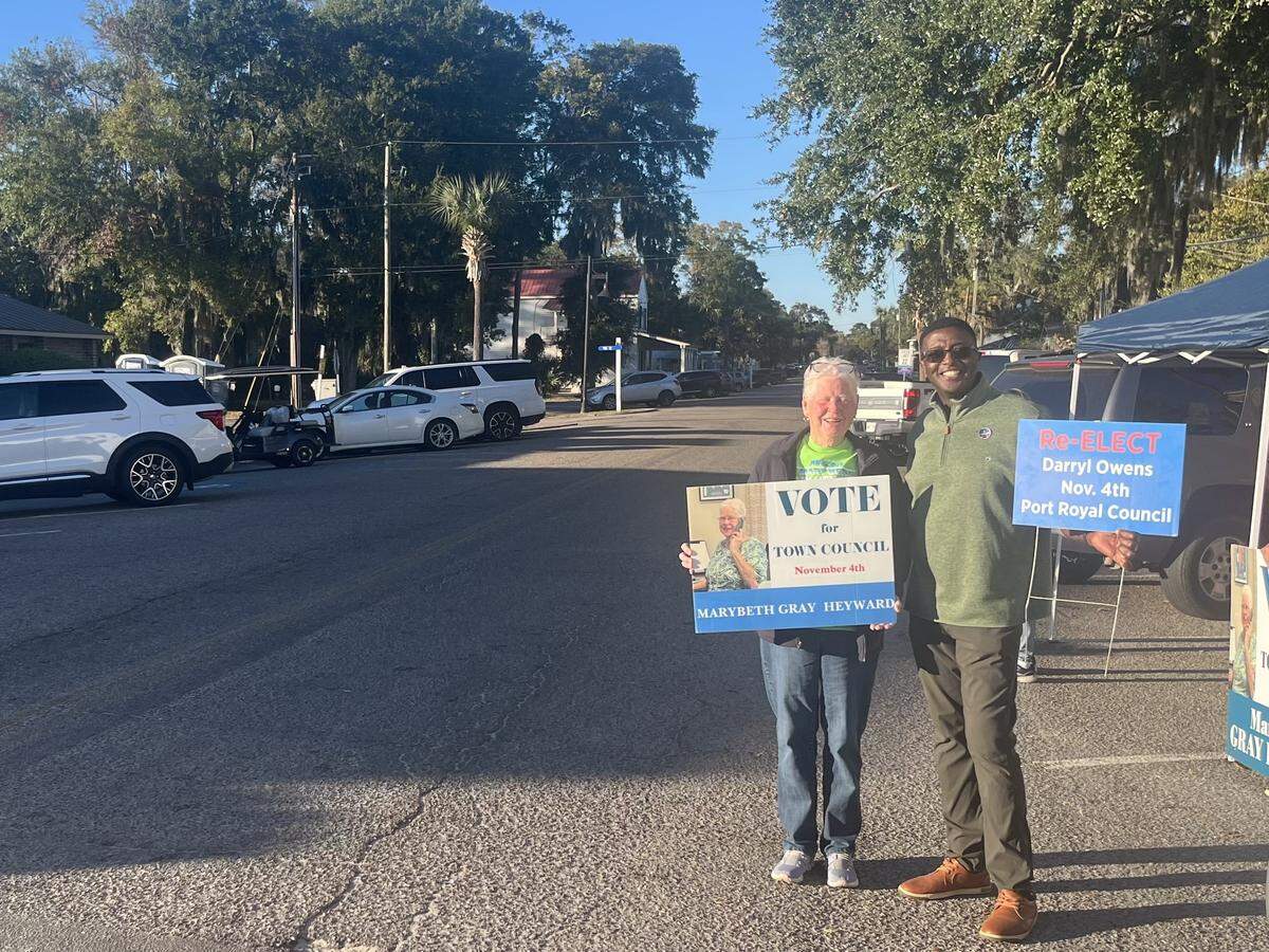 Mary Beth Gray Heyward and Darryl Owens campaign on Paris Avenue Tuesday afternoon as voters drive past on their way to Town Hall to vote.