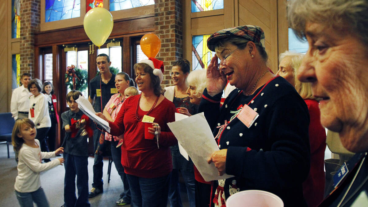 File: Volunteer carolers sing Christmas songs as people enter at First Presbyterian Church for the Community Christmas Day Dinner on December 25, 2014.