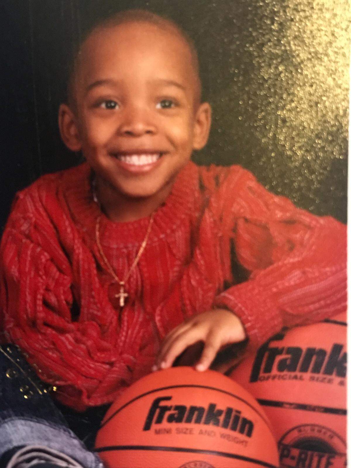 Multiple pictures of Malik with basketballs are found in the pages of a scrapbook for the missing teen.