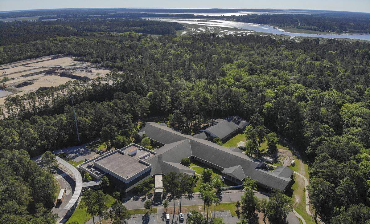 Okatie Elementary School, center, sits between two future developments as seen in this photo taken on Friday, May 1, 2020 in Okatie with the winding Okatie River, top, as the backdrop. Cleared of trees is Malind Bluff, left, a gated community approved for 345 single family homes. Developers for River Oaks, the forested area top right, plan to use the 2008 development agreement with Beaufort County, which allows for 330 single and multi-family homes.