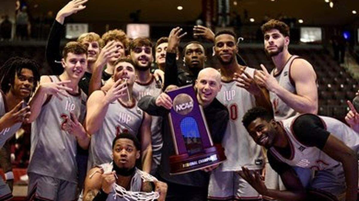 Indiana University (Pa.) assistant Ron Fudala celebrates with players after winning a region championship. Fudala was named first men’s basketball coach at USC Beaufort.