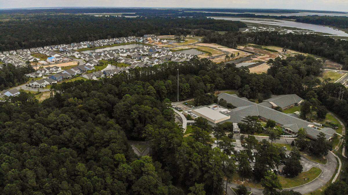 Pictured at top left is Malind Bluff, a residential development that had cleared its land in 2020 and Okatie Elementary, bottom right, along S.C. 170 in Okatie. A developer has asked Beaufort County to change zoning for nearly 72 acres south of the elementary school, not pictured, from rural to neighborhood to allow for residential construction as well as some commercial, such as hotels and general retail. Staff recommended the change because it would make a walkable community between the new development, Malind Bluff and Okatie Elementary School.