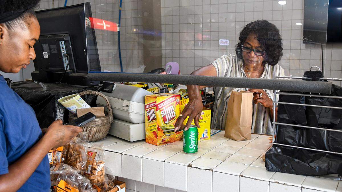 A customer waits as Harriet Chaplin bags their groceries on Wednesday, June 26, 2024 at Chaplin’s Grocery on St. Helena Island. This year will mark 50 years the family-owned store has been in operation.