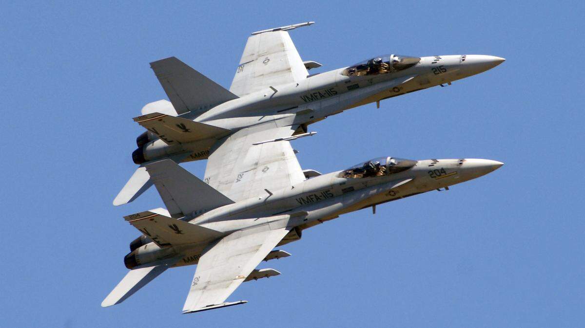 FILE: A pair of F-18s from VMFA-115 jet past in close formation at the Beaufort Air Show in May 2011.