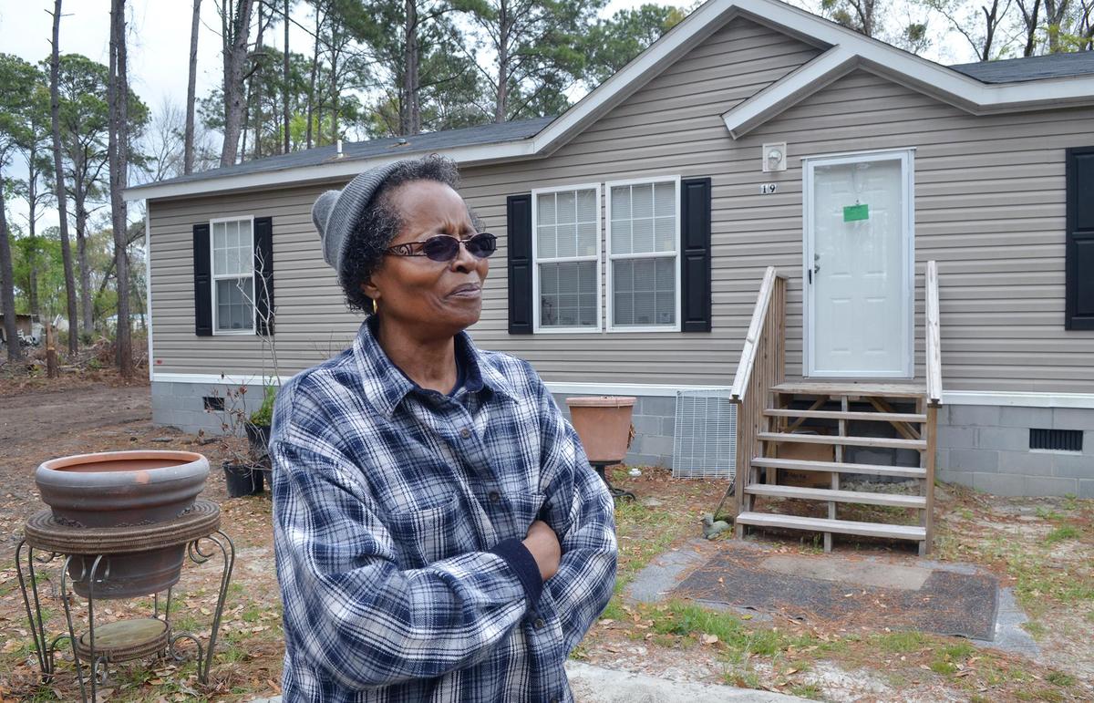 Doris Grant recently was able to shut down her septic system when she hooked into the sewer system. Here, she is photographed on March 26 in front of her Rhiner Drive home.
