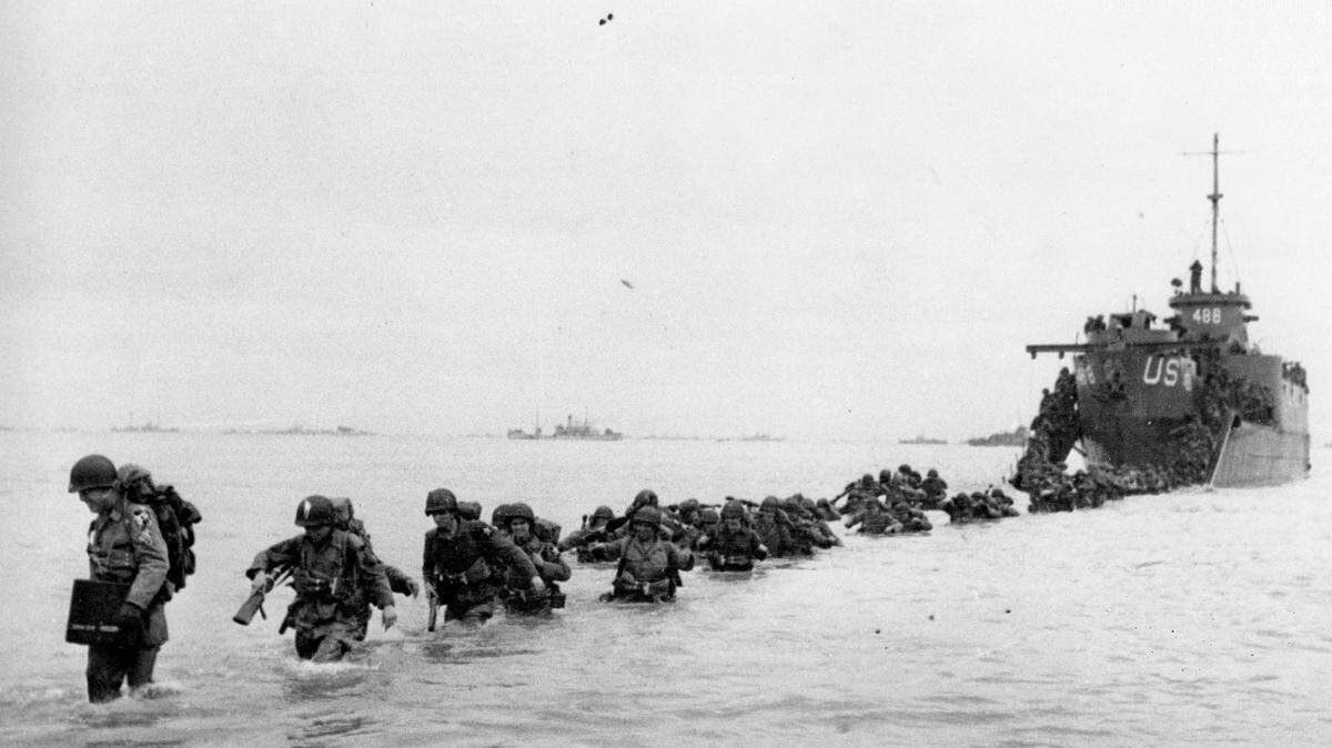 U.S. reinforcements wade through the surf from a landing craft in the days following D-Day and the Allied invasion of Nazi-occupied France at Normandy in June 1944 during World War II. From the first sketchy German radio broadcast to the distribution of images filmed in color, it has taken decades for the full story of the D-Day invasion to come out. As world leaders and veterans prepare to mark the 70th anniversary of the invasion this week, multiple Twitter hashtags are following the ceremonies minute by minute. At the time, the reporting, filming and taking of photos was neither easy nor straightforward. Photographs by Robert Capa who was embedded with U.S. troops on Omaha Beach, took more than an week for his images to reach American news.