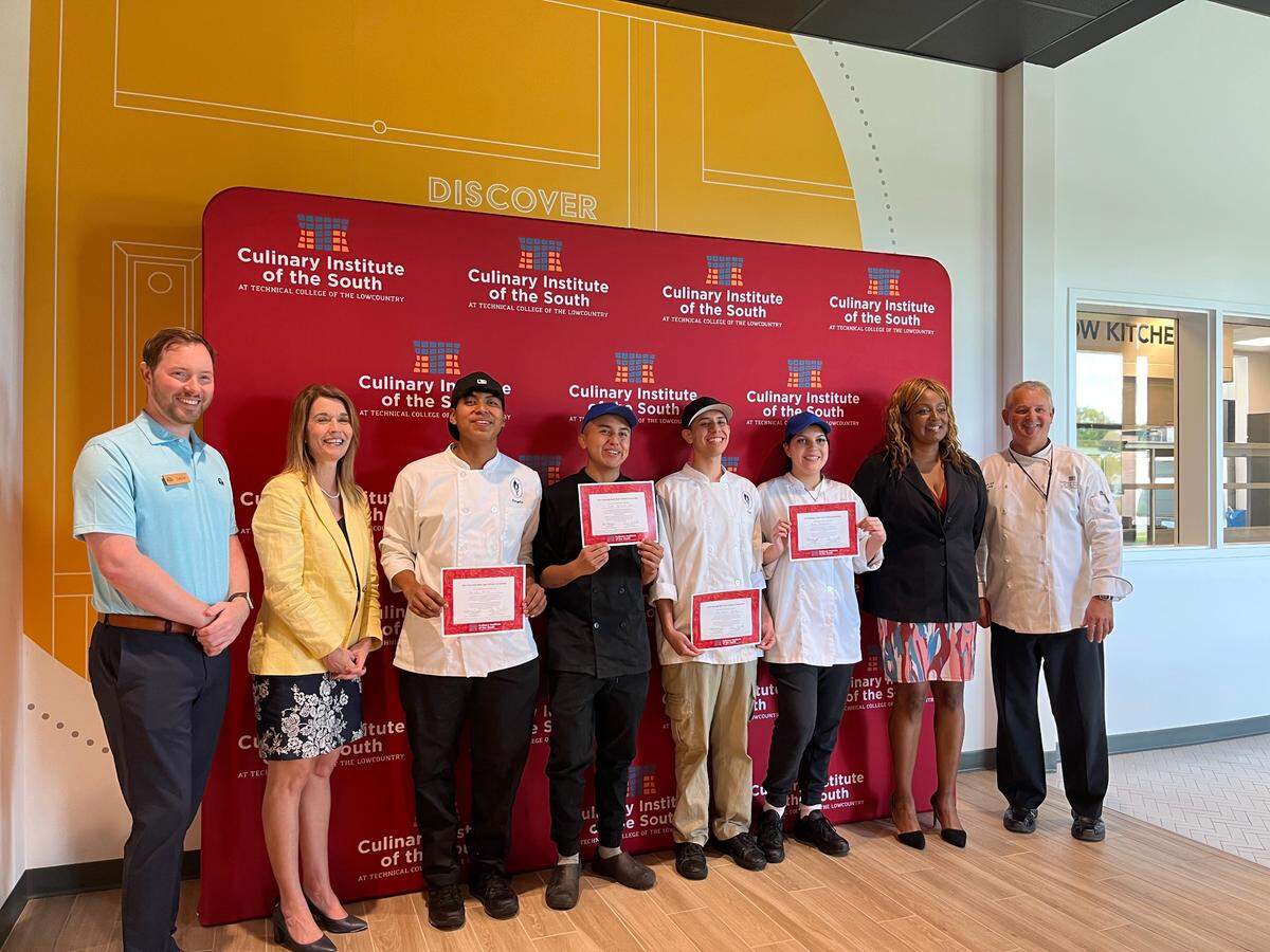 Beaufort-Jasper Academy students grin after their team won a Palmetto Bluff Club $1,000 renewable scholarship and professional knife kits to pursue a degree at the Technical College of the Lowcountry’s Culinary Institute of the South