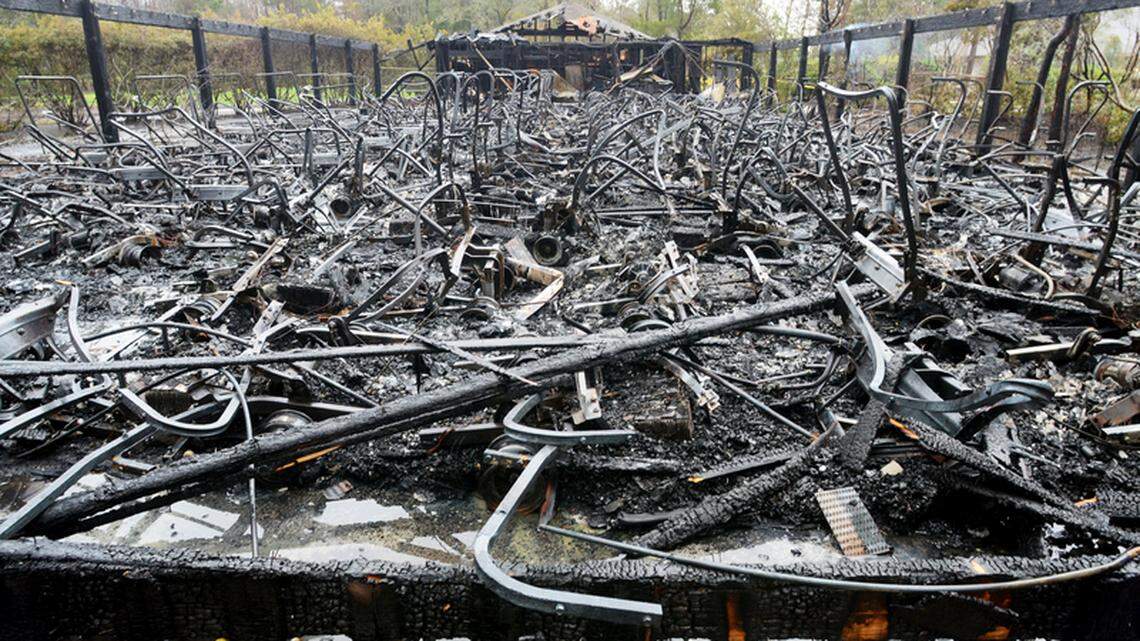 The blackened frames of golf carts were all that remained in the still-smoldering wreckage of the Eagle's Pointe Golf Club cart barn Saturday after a fire the night before destroyed the structure.