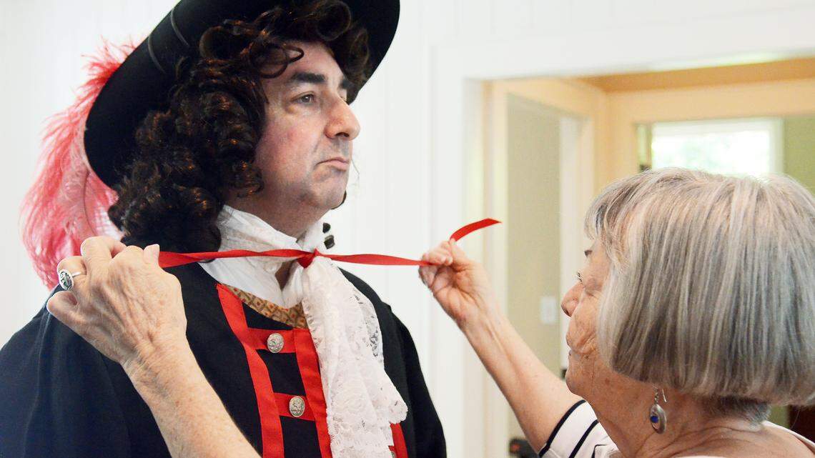 Peggy Pickett helps get her son, Dwayne Pickett, ready to go on as the English explorer Capt. William Hilton at the Coastal Discovery Museum on Thursday. "I have to see that his bow tie is tied properly," she said. Hilton Head Island takes its name from the explorer, who sighted it 350 years ago while exploring the Southeast coast.