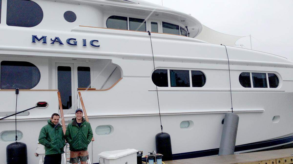 First mate Darren Jones and deckhand Ryan Walrath in front of Magic, a 130-foot yacht docked in the Harbour Town Yacht Basin on April 18, 2014.