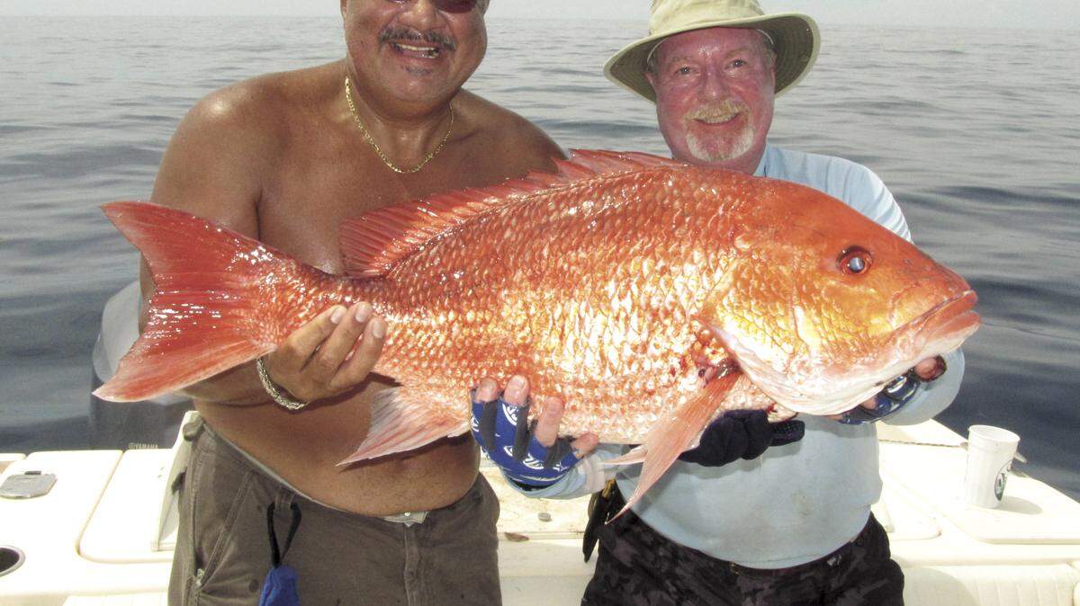 Harry Morales and Don McCarthy hold up a fine red snapper.