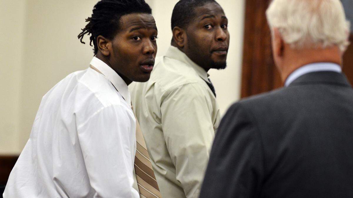 In this file photo, Aaron Scott Young Jr., 20; left, and his father, Aaron Scott Young Sr., 37, leave the courtroom at the Beaufort County Courthouse.