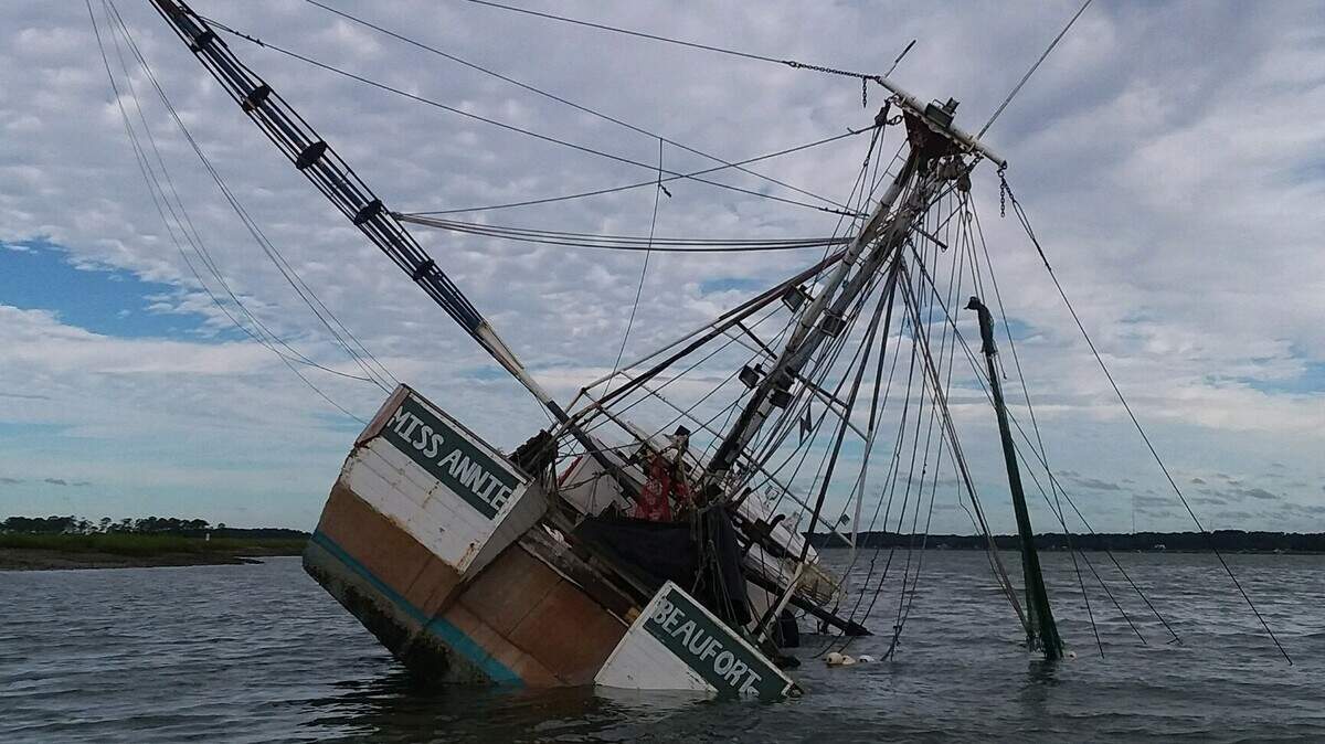 A shrimp boat rests on its side in the May River on Saturday, Sept. 15, 2018 The boat was anchored off of Bull Island to ride out Hurricane Florence, overturned and appears to have leaked fuel into the water.