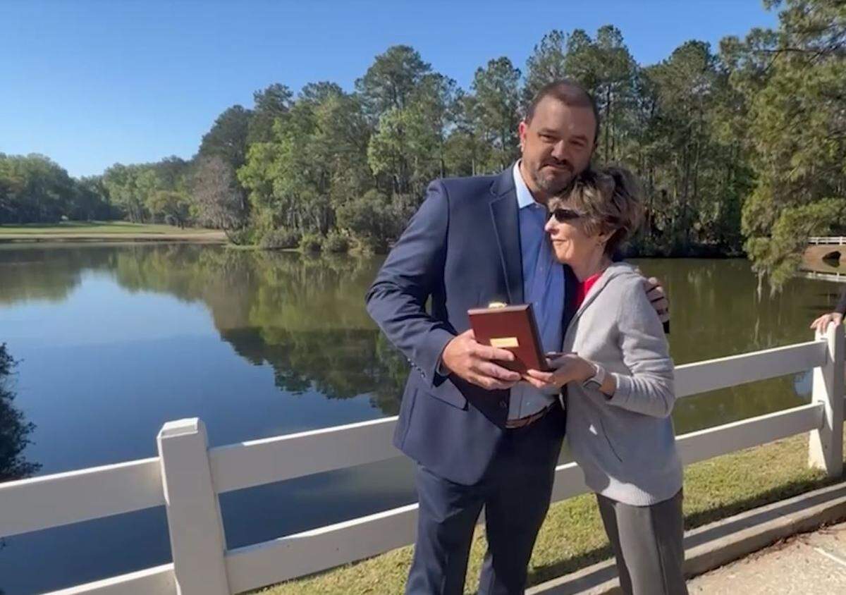 Brian McCarter (left) hugs Carol DeLillo (right), who he saved from an alligator attack in July 2020. McCarter was awarded the prestigious Carnegie Medal for his heroism.