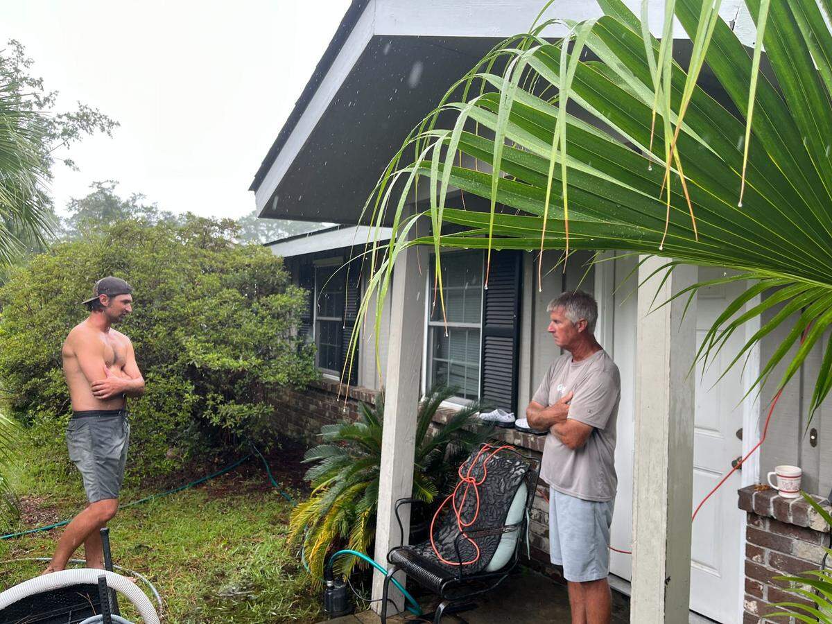 Marlin and Greg Clark have been pumping water out of the yard since Monday night and said that water hadn’t yet entered the house at Bay Pines Drive on Hilton Head Island, South Carolina, Tuesday, Aug. 6, 2024.