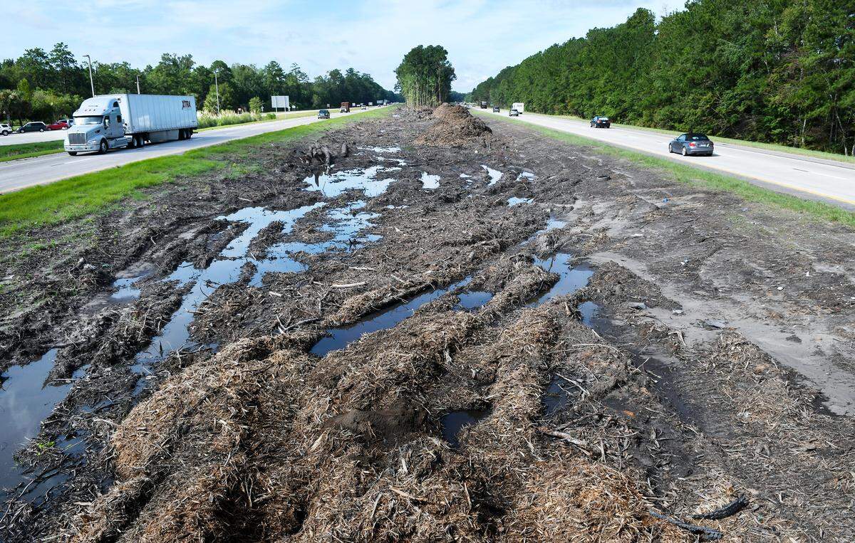 Traffic moves past an area of I-95 where the trees in the median had just been cut down and removed in this view looking south. This photo was taken on Monday, Aug. 20, 2018 near mile marker 4.