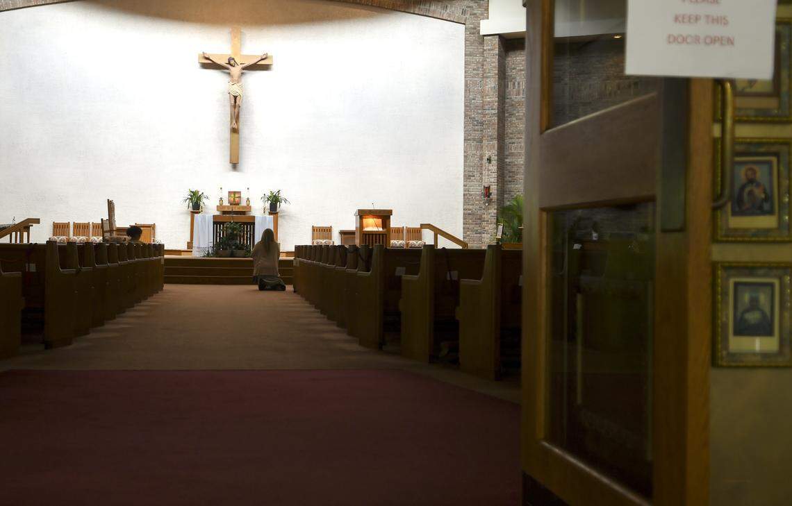 A parishioner genuflects upon entering the sanctuary of St. Francis by the Sea Catholic Church on Wednesday, May 6, 2020, on Hilton Head Island. While all masses were suspended on March 24, 2020 by the Roman Catholic Diocese of Charleston due to the coronavirus, the church remains open for personal prayer from 8 a.m. to 4 p.m.