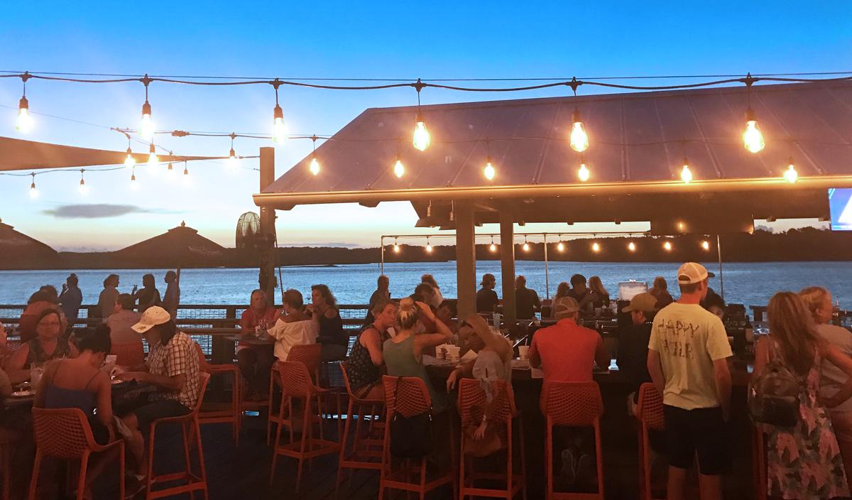 The sun sets over the deck at Hudson’s Seafood House on the Docks.
