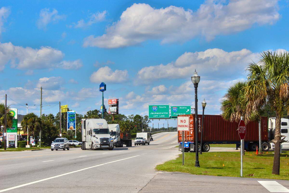 Trucks drive through the intersection of I-95 and Whyte Hardee Boulevard in Hardeeville, South Carolina on Oct. 16, 2025.