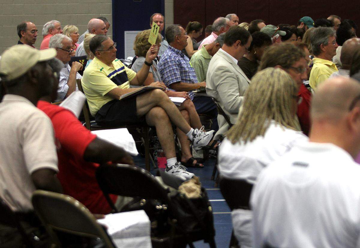 Michael Masters, middle, places a bid on a piece of property up for auction during the annual delinquent tax sale in Beaufort on Monday morning.