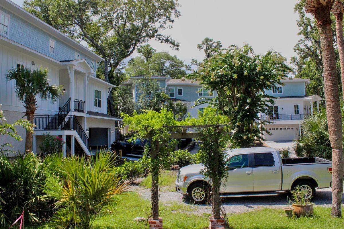 Three-story vacation homes encircle a small cul-de-sac near John and Stephanie Brighton’s home on Shell Midden Lane. The Brightons knew homes were being built across the street from their one-story home, but they didn’t expect short-term-rentals that would sleep 18 to 20 people each.