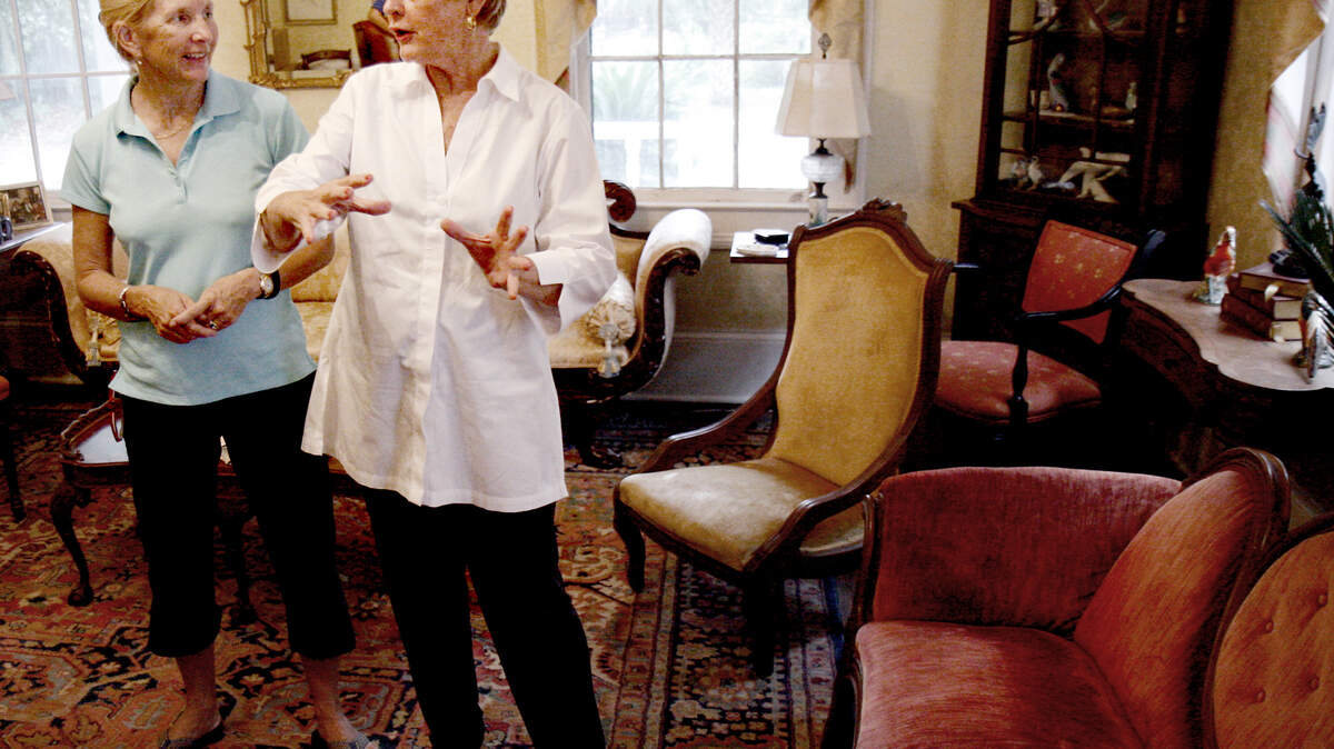 Florida resident Carrie Greene, left, chats with Barbara "Cookie" Goodwin, owner of the Oaks Plantation home on St. Helena Island on Tuesday morning. Three pieces of period furniture, two of which can be seen at right, were brought by Greene who was looking for a "good home" for the furniture.