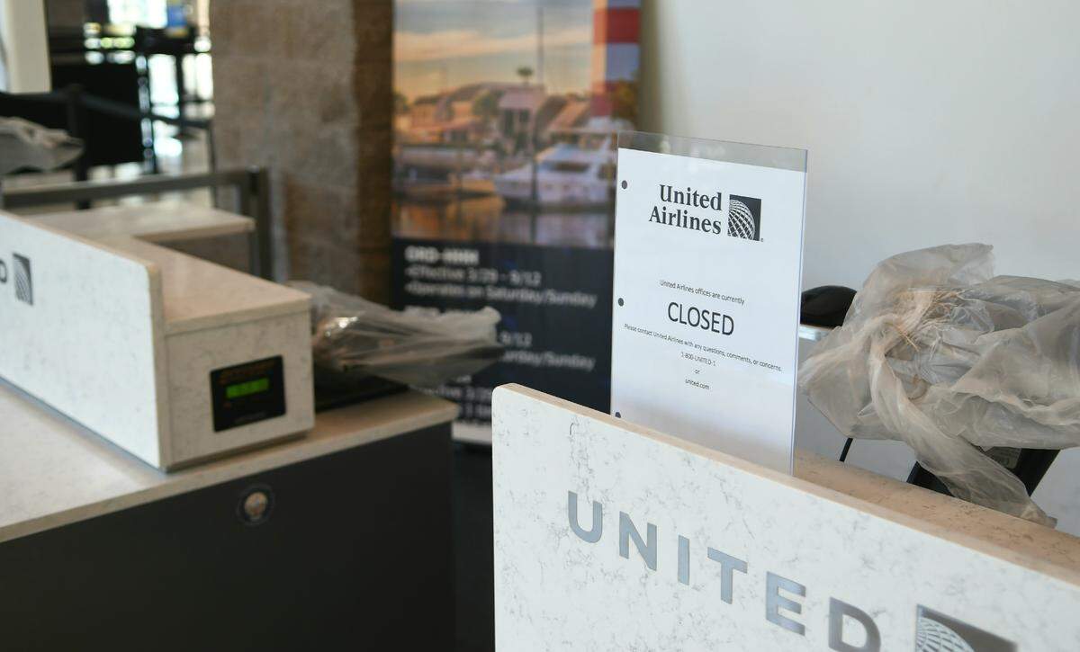 United Airlines ticket machines were wrapped in plastic with signs saying the airline was closed on Thursday, March 26, 2020, at Hilton Head Island Airport. 