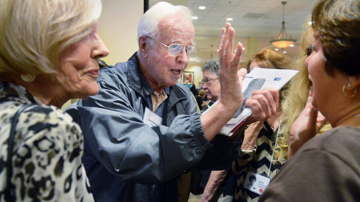William Dufford, principal of the Beaufort High School class of 1964, greets former student Mary Alice (Taylor) Hinshaw, right, during the class' 50th reunion dinner on Saturday in Beaufort. "He was the greatest administrator principal ever," said Hinshaw.