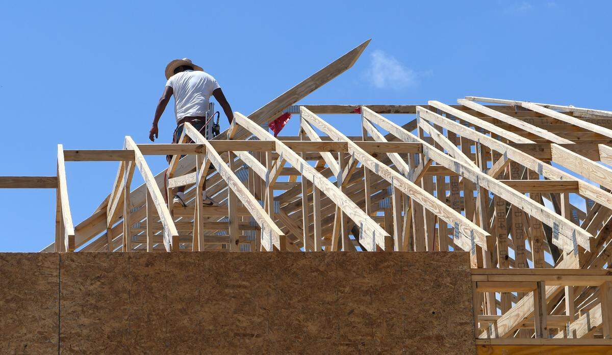 A contractor balances on the trusses of a roof in the second phase of Cypress Ridge of a home being built along Lou Baris Mill Lane on Thursday in Bluffton. In 2017, Cypress Ridge was one of the fastest growing neighborhoods in the greater Bluffton area.