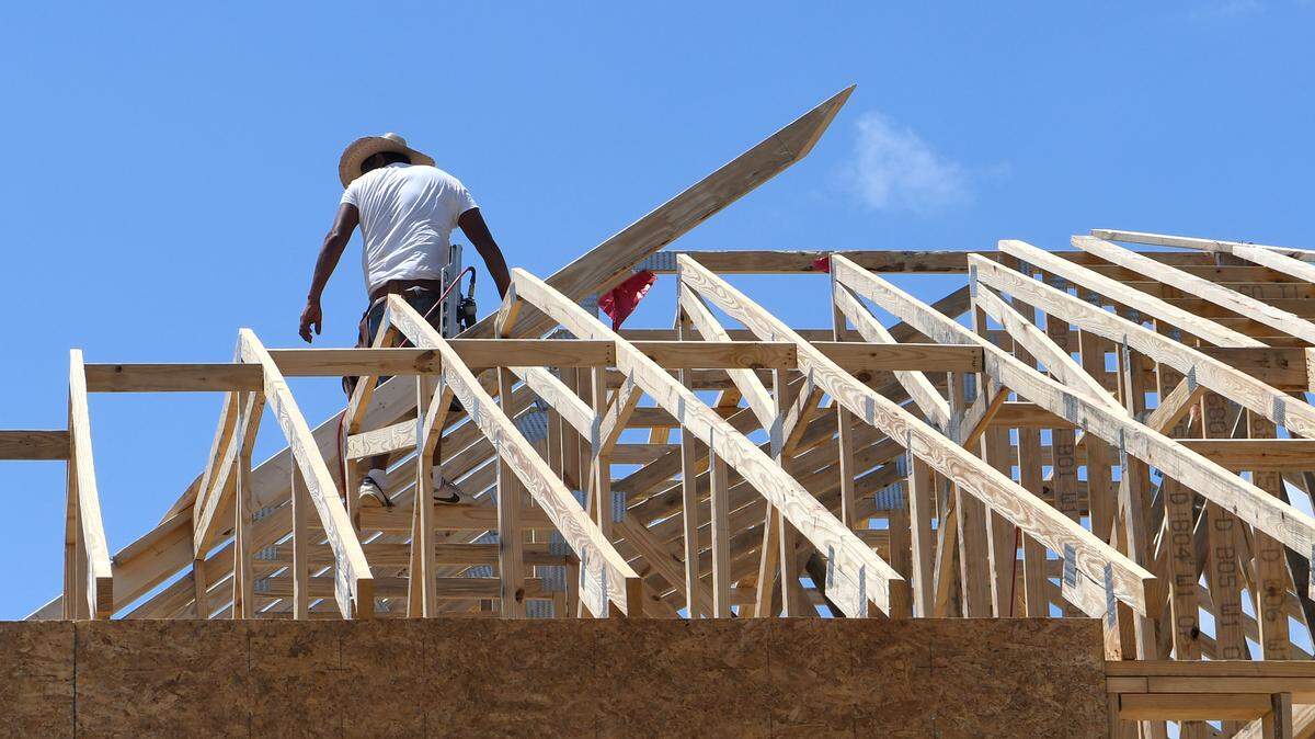 A contractor balances on the trusses of a roof in the second phase of Cypress Ridge of a home being built along Lou Baris Mill Lane on Thursday in Bluffton. In 2017, Cypress Ridge was one of the fastest growing neighborhoods in the greater Bluffton area.