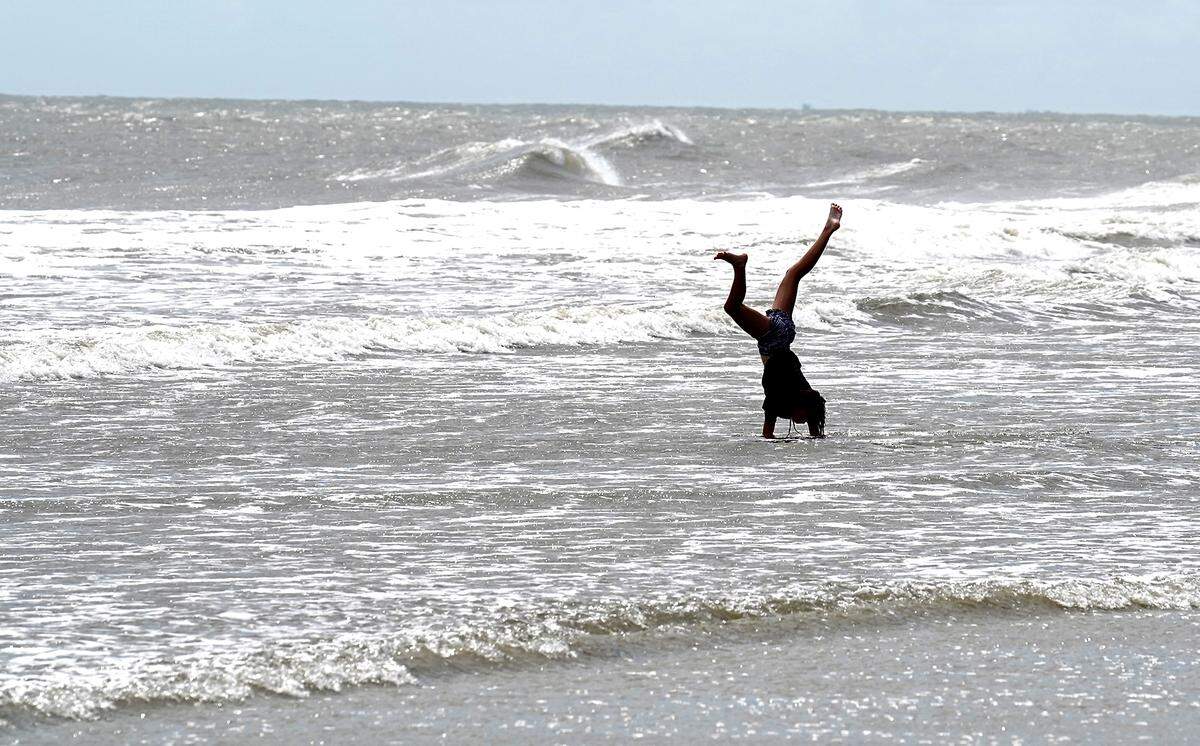 Elizabeth Smith enjoys performing cartwheels in the surf along the beach at Coligny Beach on South End in Hilton Head Island, SC on Tuesday, September 3, 2019.