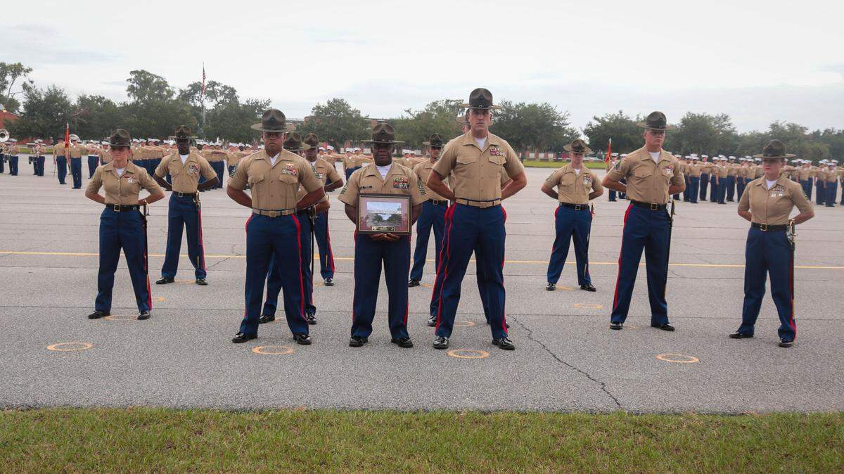 Sgt. Major William Carter holds a plaque he received at Friday’s Marine Corps Recruit Depot graduation ceremony. Carter is retiring.
