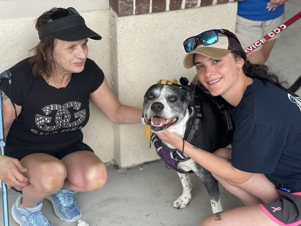 Mother Jackie Kuhn (left) and sister Paige Kuhn (right) pose with John Kuhn’s beloved dog, Pepper, at Lowcountry Celebration Park on Sep. 27, 2025. 