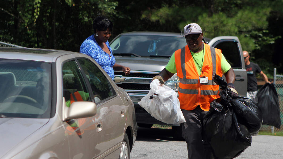 David Frazier, an employee at the Beaufort County Convenience Center on Castle Rock Road, helps people unload their trash on July 1 in Beaufort.