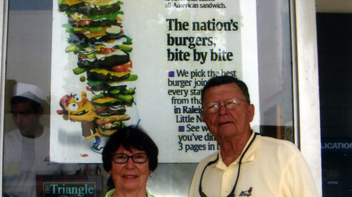 Doris and Joe Lindner pose by the USA Today poster at the Char-Grill in Raleigh, N.C. During the past two years, the couple â€" retired doctors living on Hilton Head Island â€" have driven to all but one of America's â€œ51 Great Burger Jointsâ€