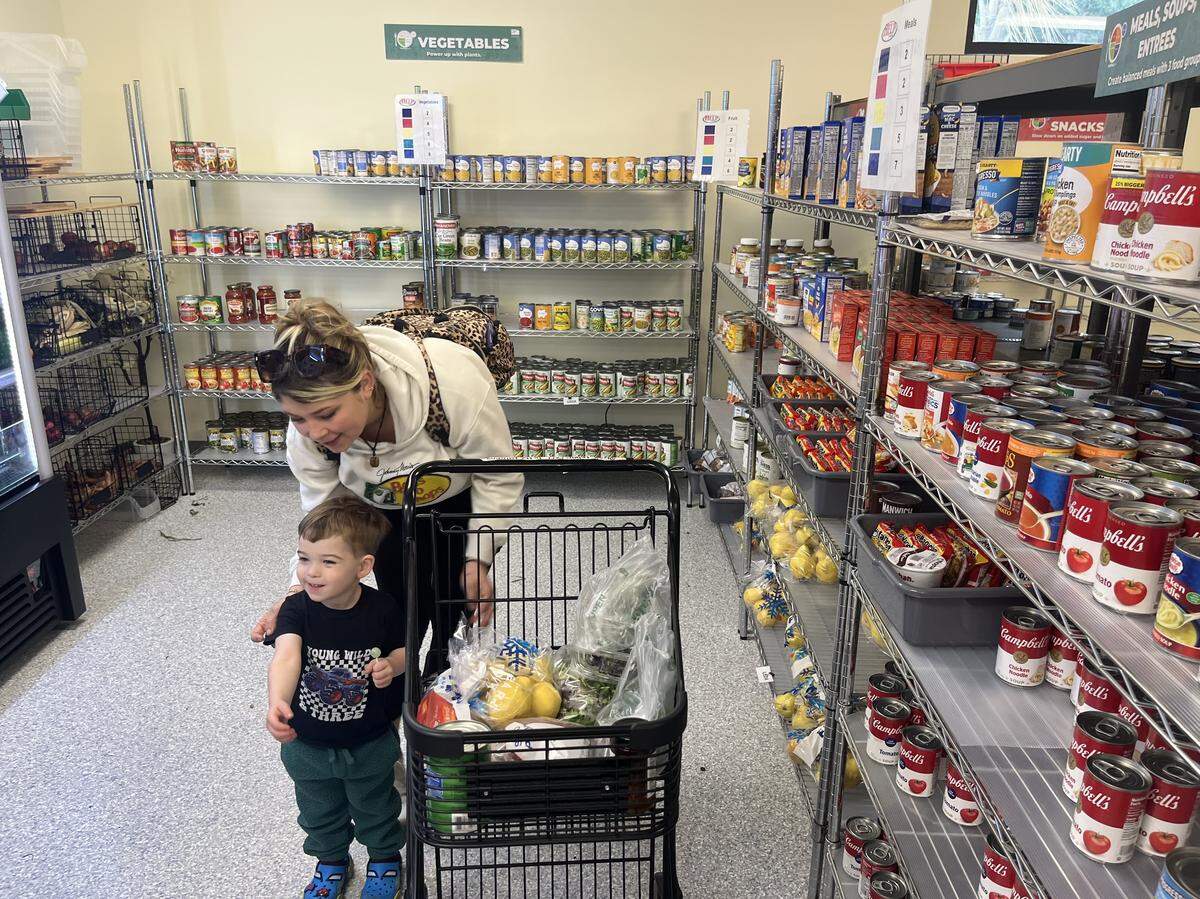 Annalee Hitchcock and her son Cylas shop at the HELP of Beaufort food pantry Monday morning. “It’s definitely helpful,” says Hitchcock.