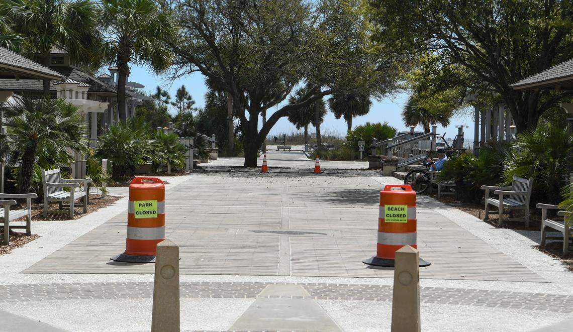 A few people rest on the benches even though two construction pylons with beach closed signs are posted on Tuesday, March 24, 2020 at Coligny Beach Park on Hilton Head Island. On Friday, Mayor John McCann closed the beach because people ignored the governors order to not congregate due to the coronavirus.
